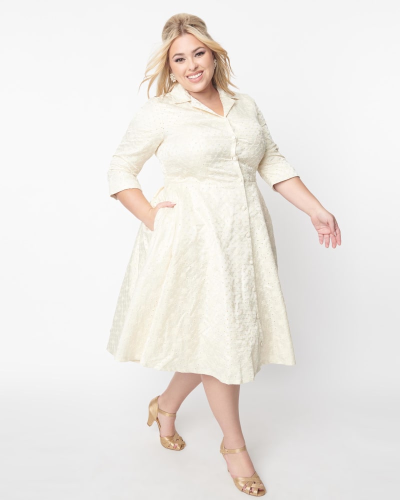Front of a model wearing a size 2X Unique Vintage Plus Size Ivory & Gold Brocade Swing Dress in Ivory & Gold by Unique Vintage. | dia_product_style_image_id:329132
